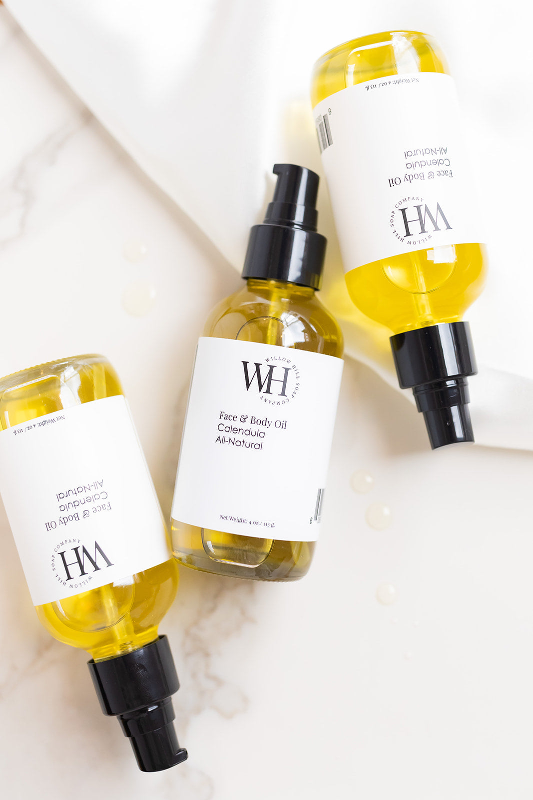Three Willow Hill Calendula Face and Body Oil bottles 